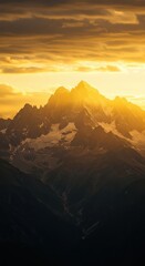 Majestic jagged mountain peaks illuminate intensely during a dramatic golden sunset