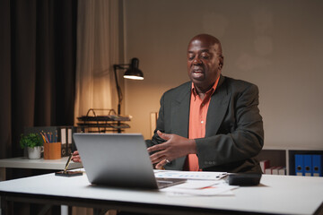 Senior black man discussing during online video call