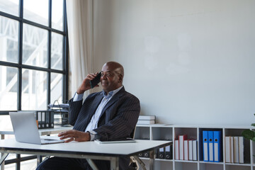 African american man talking on cell phone in office