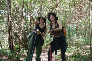Young women friends enjoying hiking in forest