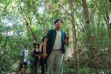 Young friends trekking through lush tropical forest