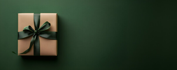 A gift box made of natural kraft paper with a green ribbon. A festive gift idea. A festive set for Christmas, a birthday, or a special occasion.