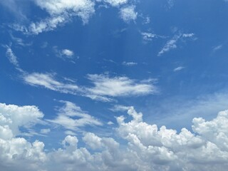 Bright blue sky with fluffy white cumulus clouds on a sunny summer day. Drone Photography