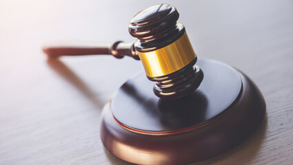 Obraz premium Wooden gavel and sound block on a table signify law and justice.