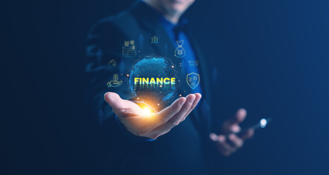 A businessman holding a glowing globe with the word FINANCE and various currency symbols such as Bitcoin, Yen, and Dollar, representing global finance, investment, and financial technology growth.