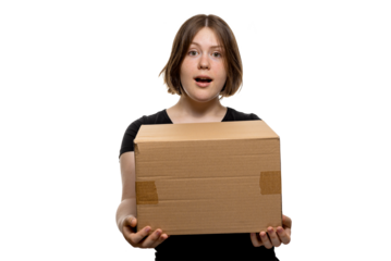 Amazed young woman holding a cardboard box with an open mouth expression, isolated on transparent background.