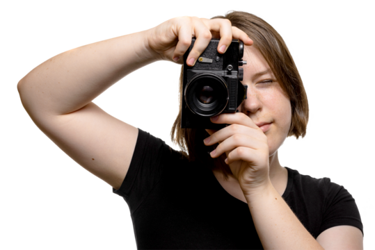 Cheerful young woman holding camera and taking a picture, isolated on transparent background.