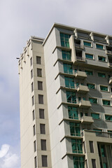 White high-rise hotel or apartment buildings with numerous windows and balconies, viewed from a low...