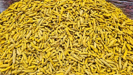 A large Pile of Dried Turmeric Fingers in a Spice Market