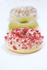 Delicious glazed donuts on white background.