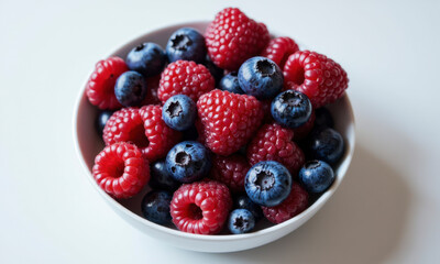 A Bowl of Summer's Bounty: Vibrant, Colorful Berries in a Clean White Bowl