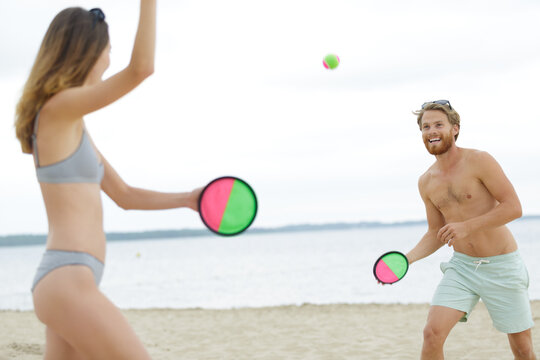 group of friends playing on the beach