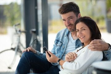 tourists consulting smart phone in a train station