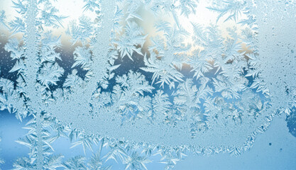 Frost pattern on window glass for winter background, Christmas concept, or abstract cold texture
