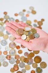 Open Hand Holding a Collection of International Coins for Global Finance or Charity