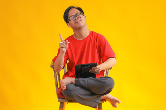Smart Young Special Boy Using Digital Tablet and Having Great Ideas with One Finger Up
