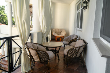 Recreation area at a country house, lounge chairs, and a hammock. Free time, relaxing, vacation at the holiday home.