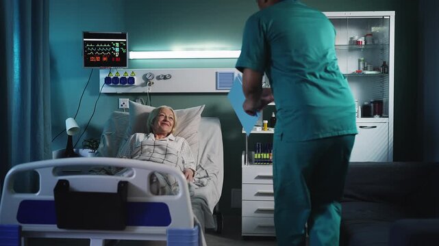 Male doctor visiting senior female patient in ICU room, checking her condition