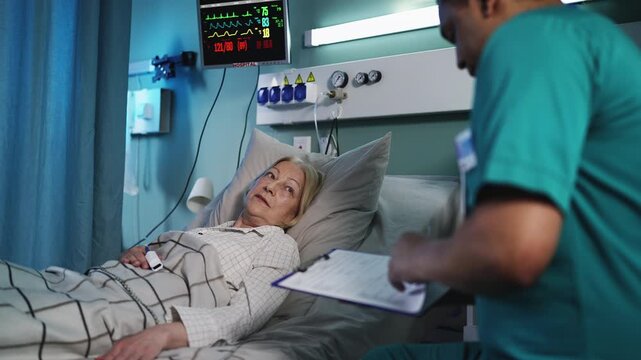 Male doctor and nurse taking care of senior woman lying in hospital ICU bed