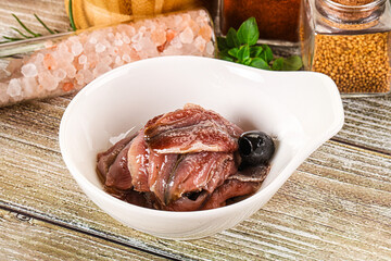 Canned anchovy with oil in the bowl