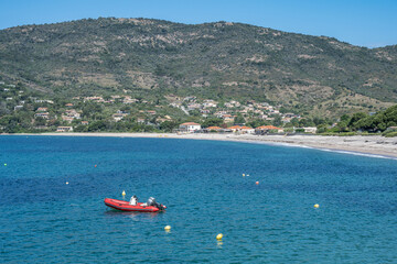 Obraz premium Spectacular view Golf at Sagone Corsica France beautyful sand Beach boats mountain village Tourism and vacations concept