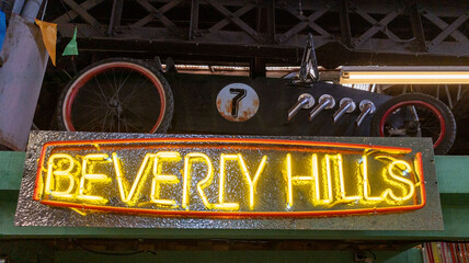 beverly hills retro style neon sign glowing front vintage pedal car custom hotrod handmade in concept lifestyle california in usa