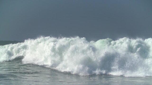 Bodyboarder riding giant swell waves at The Wedge