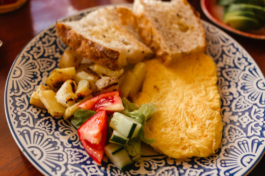 Omelet with vegetable salad for breakfast. Delicious meal in the morning