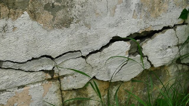 Old concrete wall texture large crack and dirty wall surface with large damage.
