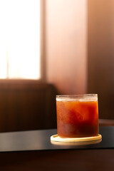 Refreshing iced drink on a wooden table in a cozy cafe during the afternoon