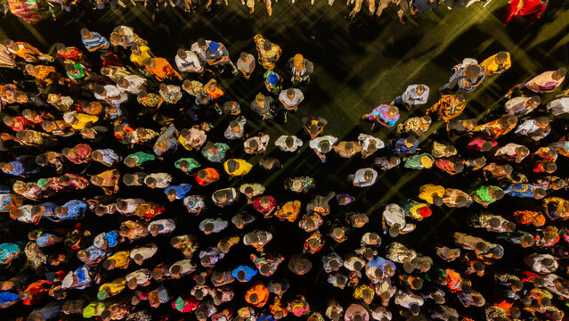 Aerial view of a vibrant crowd near Hospital Road, a kaleidoscope of colors and textures under the night sky, Port Harcourt, Port Harcourt, Nigeria.