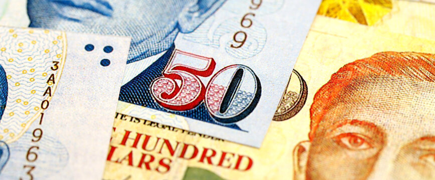 Singapore Dollar currency money bills. SGD currency banknotes in bunch with different denomination close up