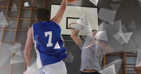 Leaping player in blue #7 jersey grabbing orange basketball at gymnasium hoop with climbing racks