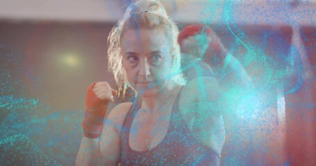 Boxer in tank top practicing guard stance in boxing gym, with red wraps and particle overlay