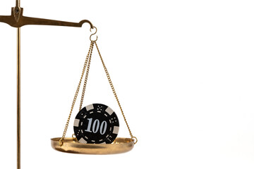 A conceptual story about ludomania (gambling addiction) with a  golden scales and casino betting chip