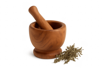 Wooden mortar and pestle with dried herbs grinding process