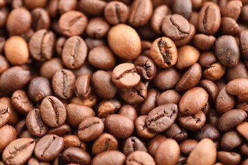 Textured background of freshly roasted coffee beans close up