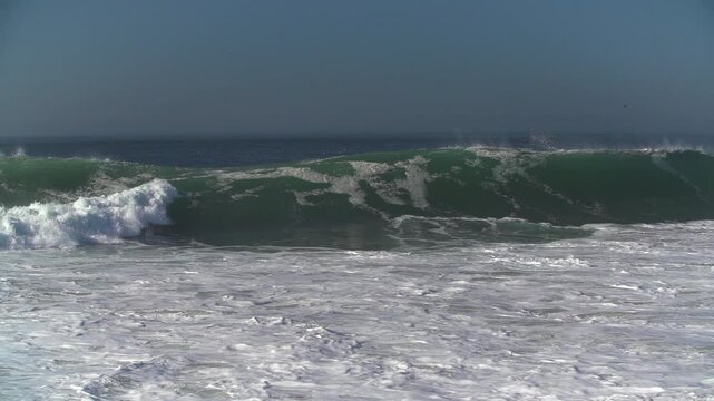 Huge waves breaking in slow motion in Newport beach