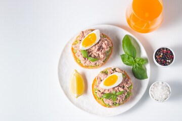 Two delicious tuna open sandwiches with avocado and boiled eggs. Tuna toast.