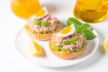 Two delicious tuna open sandwiches with avocado and boiled eggs. Tuna toast.