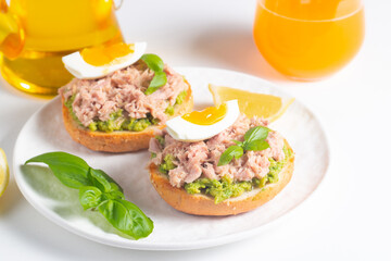 Two delicious tuna open sandwiches with avocado and boiled eggs. Tuna toast.
