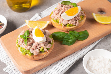 Two delicious tuna open sandwiches with avocado and boiled eggs. Tuna toast.