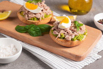 Two delicious tuna open sandwiches with avocado and boiled eggs. Tuna toast.