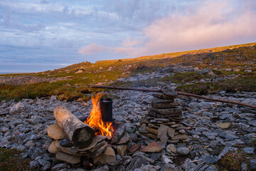 Campfire on the shore of the Barents Sea. North, Russia, Murmansk Oblast.