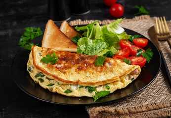 Omelette with cheese, tomatoes and green herbs. Omelette, salad and toast. Keto, ketogenic lunch. Healthy breakfast.