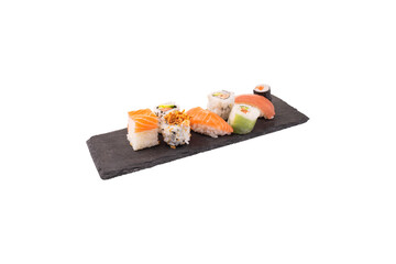Side View of Assorted Sushi and Maki Rolls on a Black Slate Plate. Elegant Japanese Food Platter for Restaurant Menu