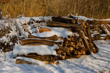 Pile of Firewood Covered in Snow During a Winter Morning