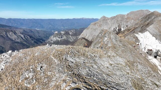 Aerial view of majestic mountains, their peaks rising against the horizon near the coastal city, a symphony of rugged textures, Levigliani, Toscana, Italy.
