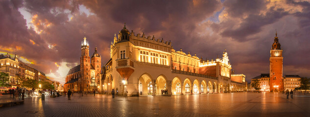 Panorama of St Mary's Basilica (Mariacki Church) and The Main Market  and tower in the Old Town of Krakow, Poland illuminated at night after sunset