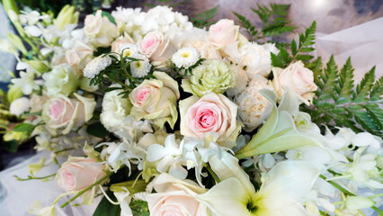 Elegant wedding bouquet with pink and white roses, lilies and lush greenery floral arrangement for special occasions